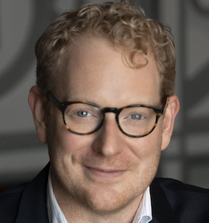 Headshot of Michael Miller, smiling at the camera.